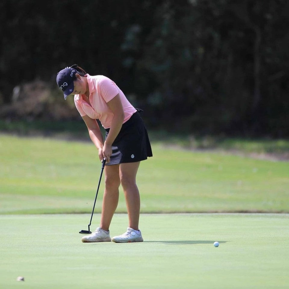 June Song putting in 13 under black skort